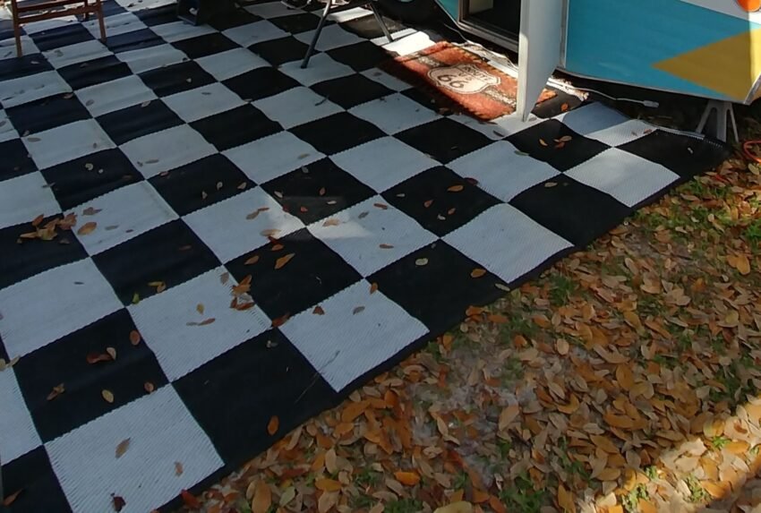 Chequered RV Rug Chequered RV mat with leaves on it.