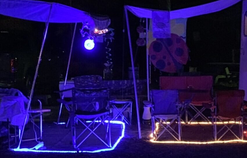 RV Rug With LED Lights Rv patio mats with LED lights around the edges lit up up at night.
