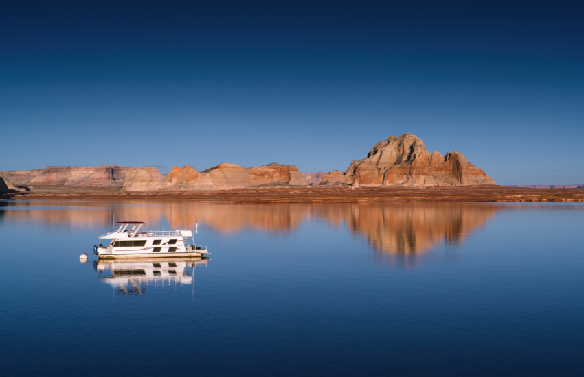 Lake Powell A boat on a blue lake with red mountains in the background.