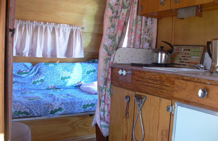 Floral fabrics in an RV with a wooden interior.