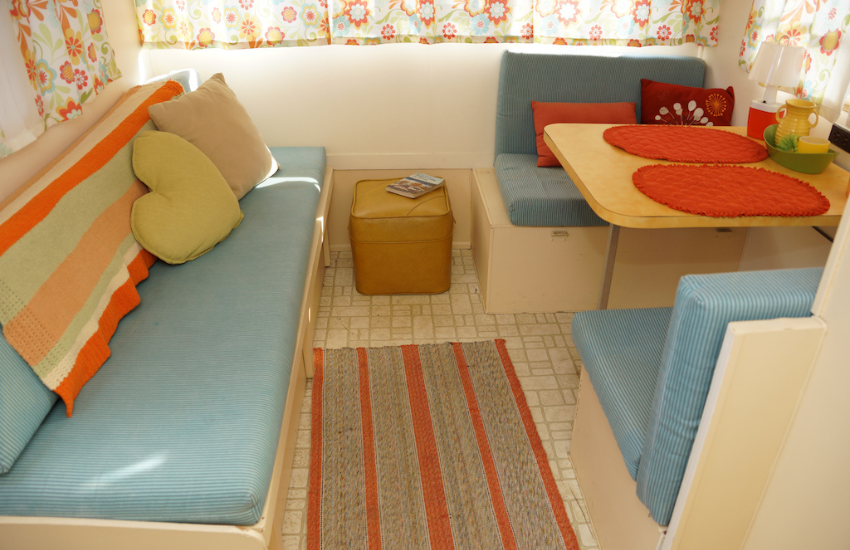 Blue bench seat in a retro camper.