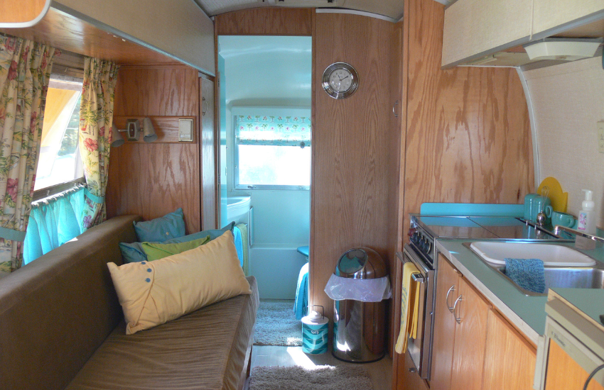 Smooth wooden surfaces inside an old travel trailer.