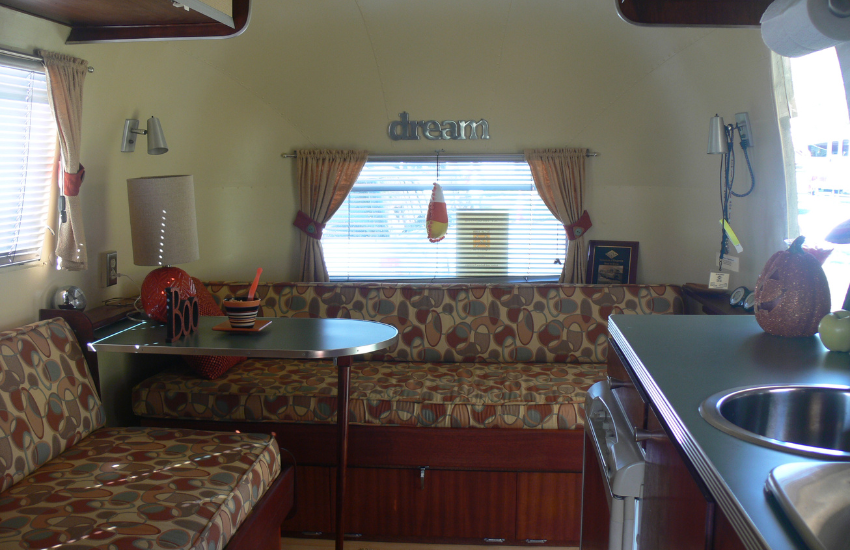 Retro patterned bench seats inside an older camper.