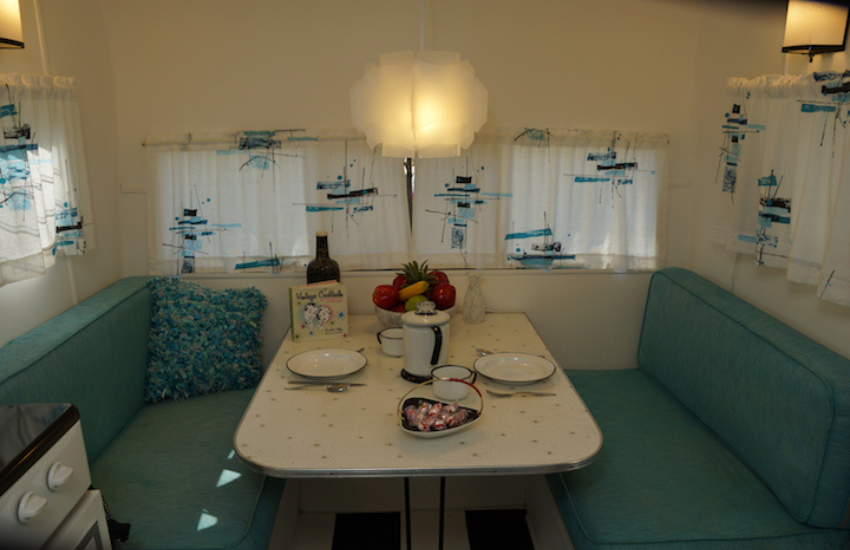 Green bench seats in an old camper dinette.