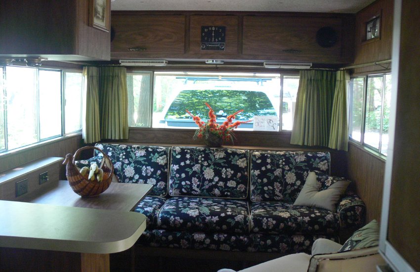 Cool vintage RV interior with floral blue seating.