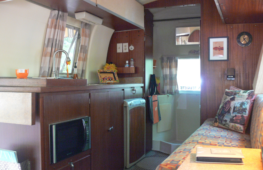 Dark mahogany cabinets in a retro camper.