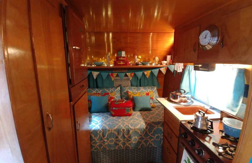 Lights refecting on the wood veneer of a vintage camper.