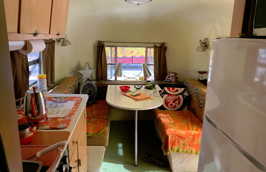The inside of a vintage camper trailer with retro accessories.