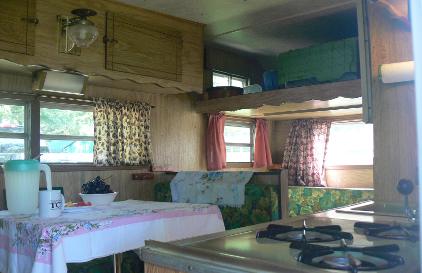 Old RV interior with wood cabinets.