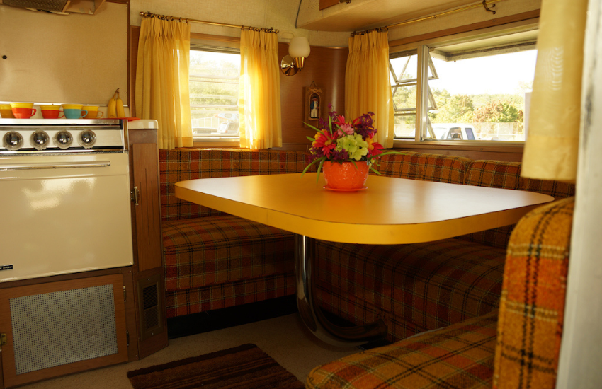 Vintage camper dinette with check dinette cushions.