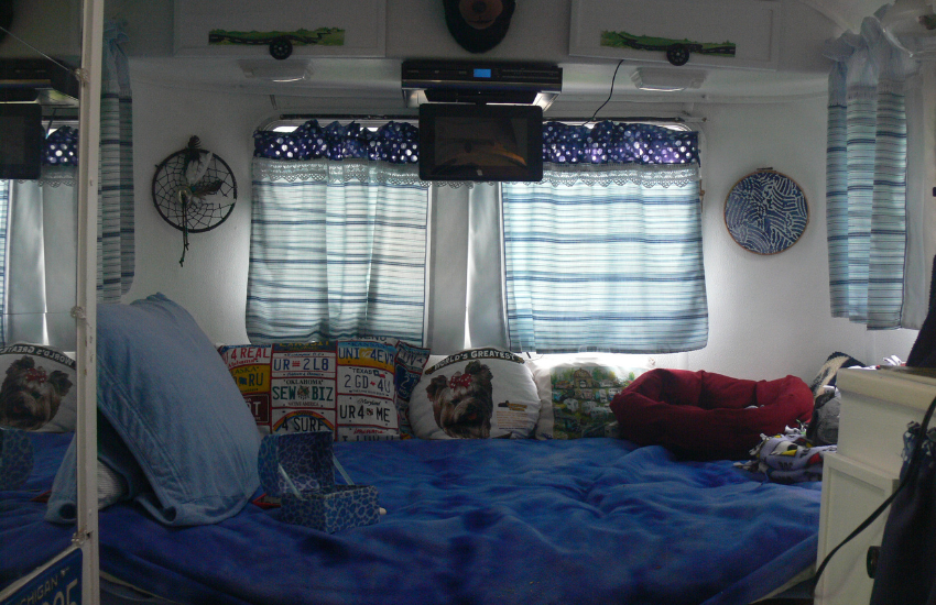 Camper Decor Ideas#15 Blue bed covers and decor in a camper.