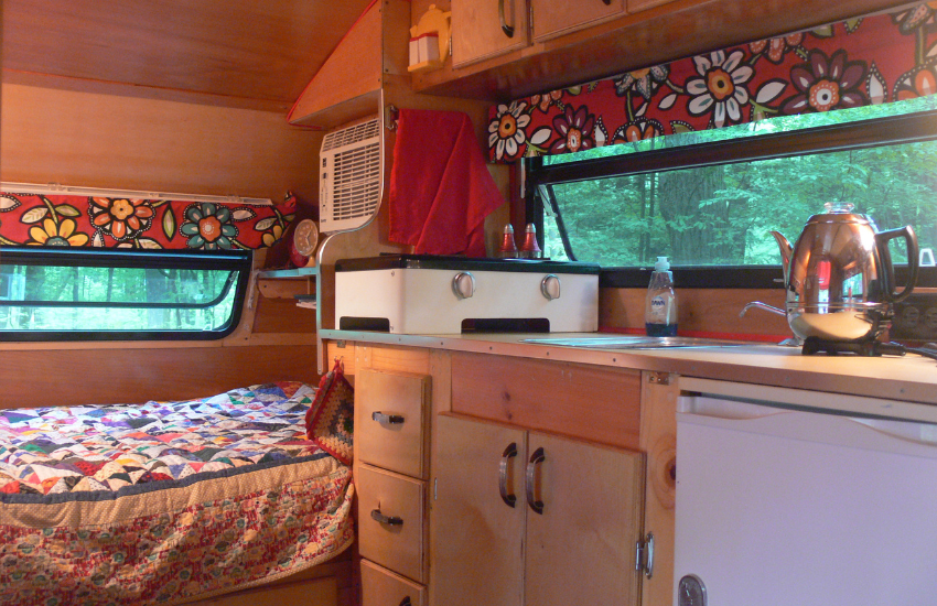 Camper Decor Ideas#24 Red patterned fabric against wooden camper interior.