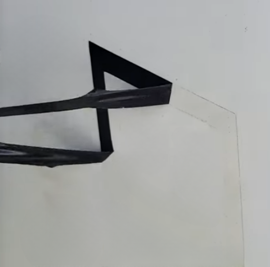 Remove Decal With Blowdryer A black decal being removed from a white surface