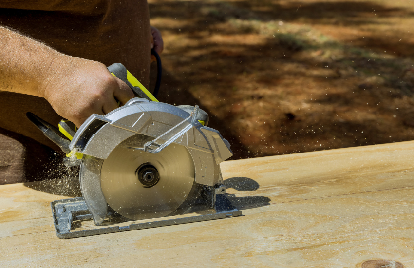 A circular saw cutting a sheet of plywood