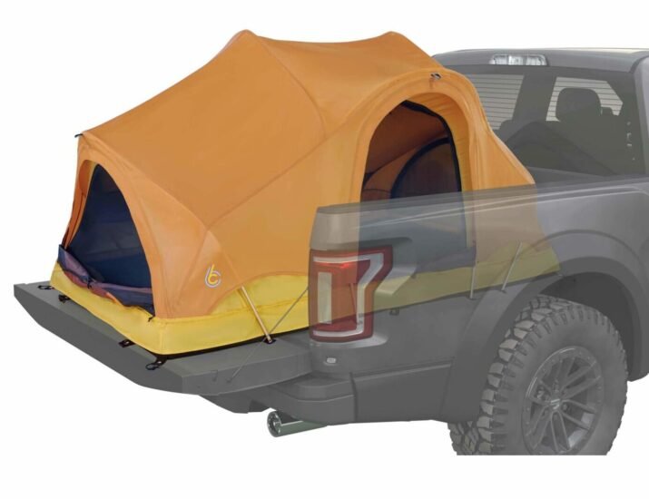 A truck bed tent in the back of a pick up.